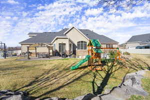 View of jungle gym featuring a patio area and a pergola