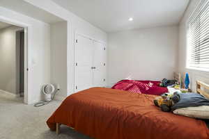 Bedroom featuring light carpet, a closet, and recessed lighting