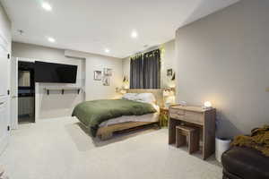 Bedroom with light carpet, recessed lighting, and ensuite bath