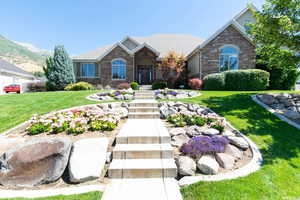 Last Summer - Craftsman house with a front lawn, brick siding, and stone siding