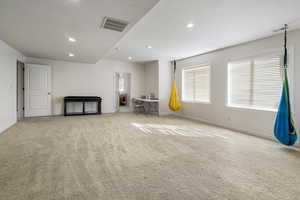 Spare room with light carpet, recessed lighting, plenty of natural light, and a textured ceiling