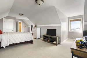 Bedroom featuring light colored carpet and baseboards