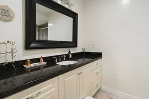 Bathroom featuring vanity and baseboards