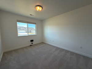 Unfurnished room featuring carpet and baseboards
