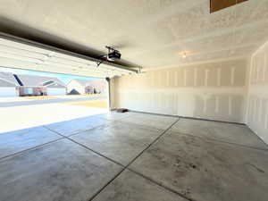 Garage with a residential view and a garage door opener