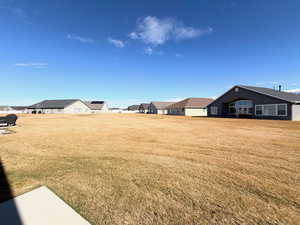 View of green lawn featuring a residential view