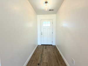 Entryway with wood-type flooring and baseboards