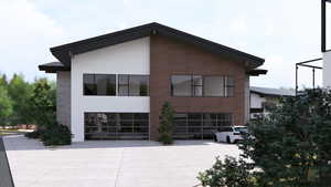 View of side of home with an attached garage, concrete driveway, and stone siding