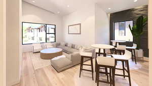 Living area featuring light wood-type flooring and recessed lighting
