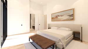 Bedroom featuring a high ceiling and light wood-style flooring