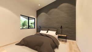 Bedroom with an accent wall, light wood-type flooring, and recessed lighting