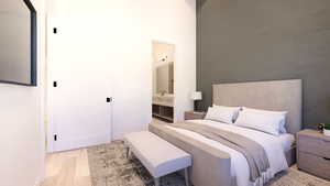 Bedroom with light wood-type flooring and ensuite bathroom