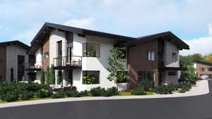 View of front facade featuring a balcony, stucco siding, and stone siding