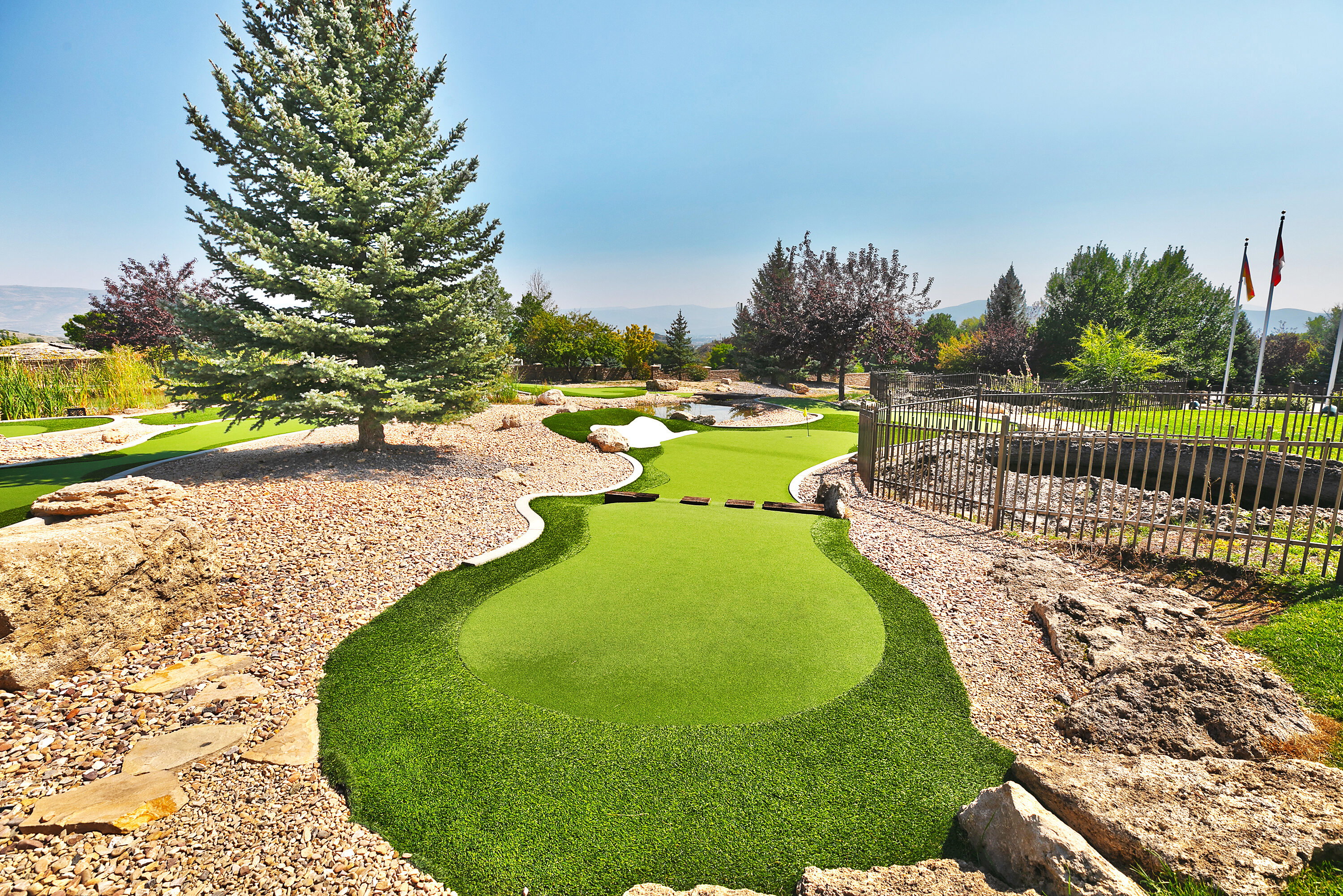 View of home's community with an area to practice putting