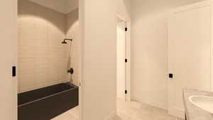 Bathroom with vanity, shower / tub combination, and light tile patterned floors