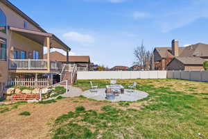 Fenced backyard with a patio area, a residential view, and a wooden deck