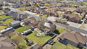 Aerial view of property and surrounding area featuring nearby suburban area