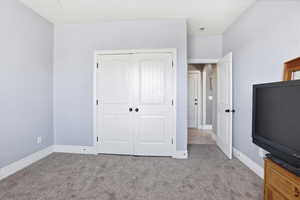 Unfurnished bedroom featuring a closet and light carpet