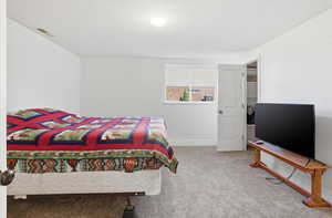 Bedroom featuring light carpet and baseboards