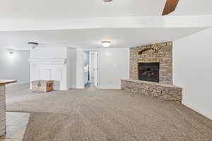 Unfurnished living room featuring a fireplace and light carpet