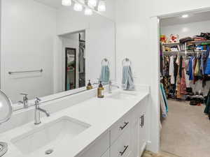 Bathroom with a spacious closet and double vanity