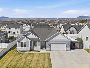 View of front facade featuring a residential view, an attached garage, concrete driveway, and brick siding