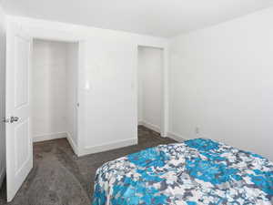 Bedroom with dark carpet