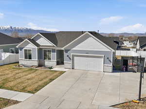 Craftsman house featuring a mountain view, driveway, an attached garage, a residential view, and brick siding