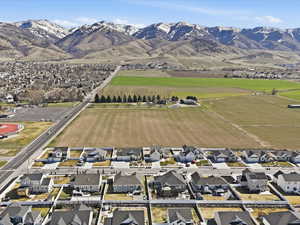 Aerial overview of property's location featuring nearby suburban area and a mountainous background