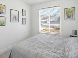 Carpeted bedroom featuring baseboards