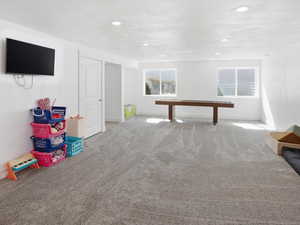 Game room featuring carpet and baseboards