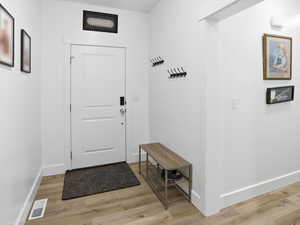 Entryway with wood finished floors