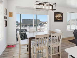 Dining area with healthy amount of natural light and light wood finished floors