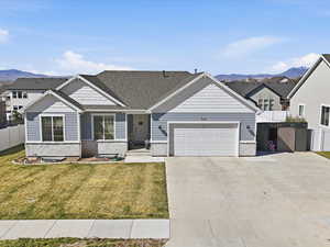 Craftsman-style house featuring a mountain view, brick siding, concrete driveway, an attached garage, and a residential view
