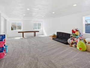 Game room featuring light colored carpet, plenty of natural light, and recessed lighting