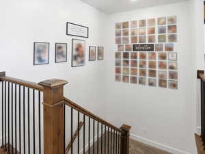 Stairway featuring baseboards and carpet flooring