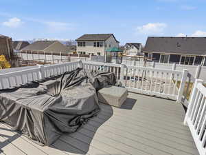 Wooden terrace featuring a residential view and a fenced backyard