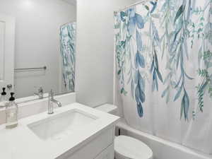 Full bathroom featuring vanity and shower / bath combo with shower curtain