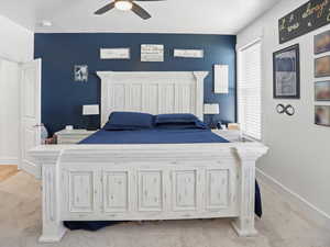 Bedroom with light colored carpet and ceiling fan