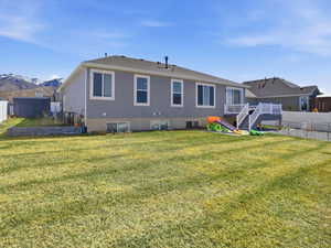Rear view of property with stucco siding and a wooden deck