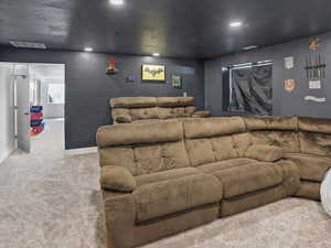 Carpeted cinema room featuring recessed lighting and baseboards