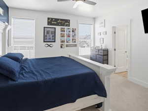 Bedroom featuring light carpet and a ceiling fan