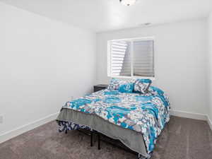 Bedroom with carpet flooring and baseboards
