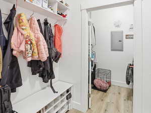 Mudroom featuring light wood-style floors and electric panel
