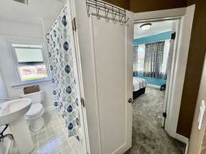 Ensuite bathroom with a textured ceiling and a shower with shower curtain