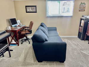 Office space featuring light colored carpet and baseboards