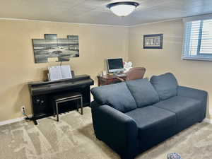 Office area featuring light carpet and baseboards