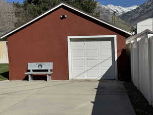 Detached garage featuring driveway and a mountain view