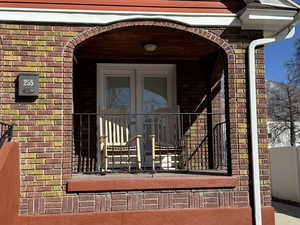 Entrance to property with brick siding and french doors