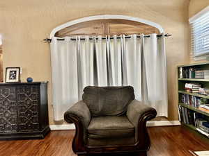 Living area with a textured wall and wood finished floors